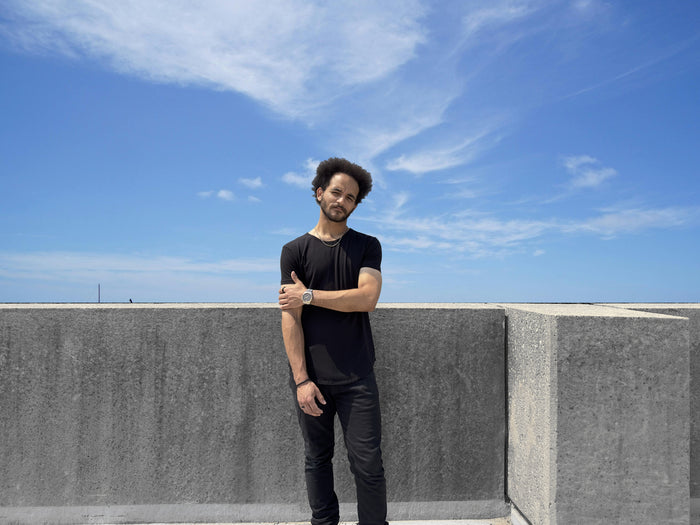 man standing in onyx black short sleeve drop cut t-shirt