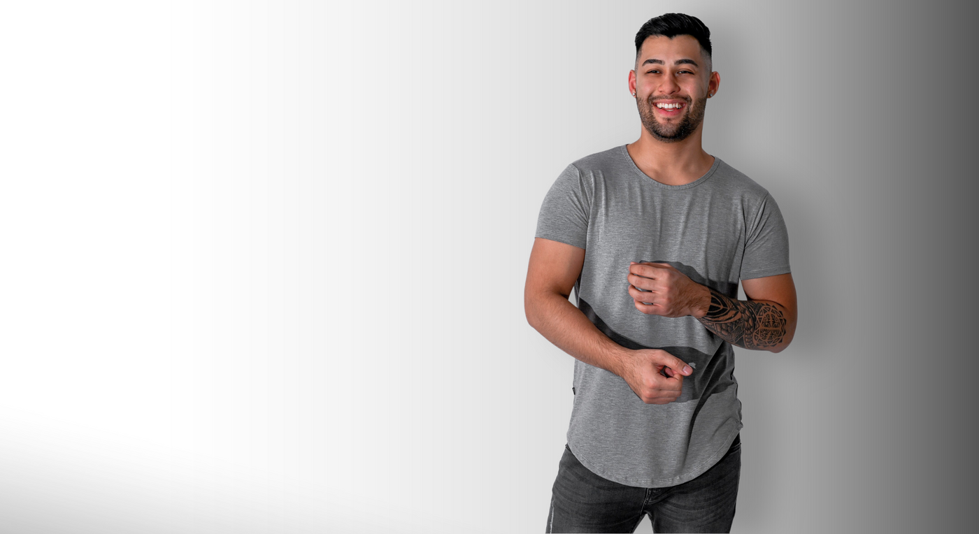 man smiling, wearing a stone grey short sleeve drop tee shirt