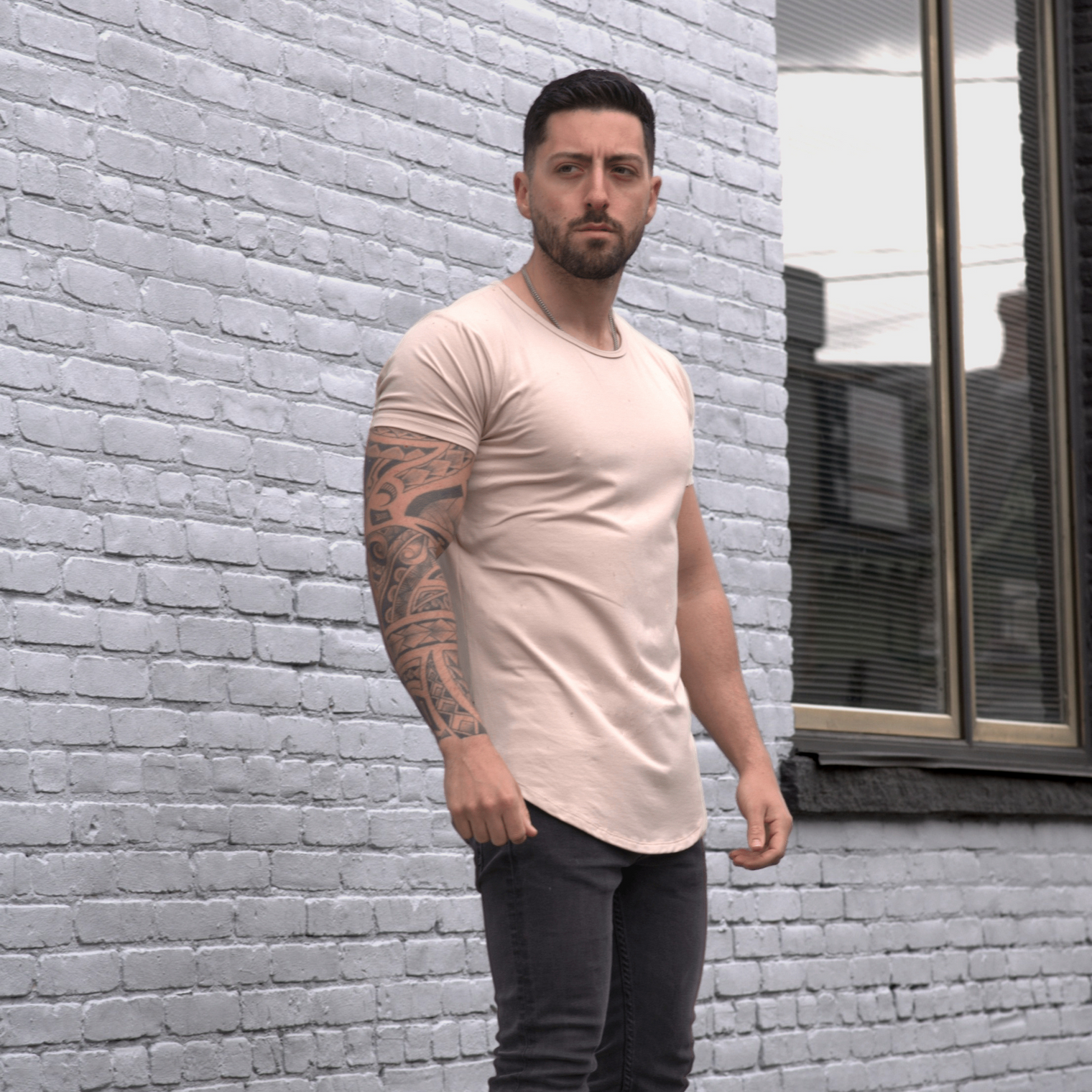 man wearing sand beige short sleeve drop tee