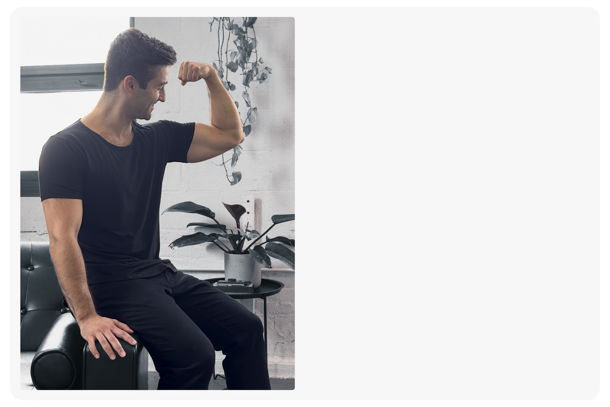 man flexing wearing the onyx black short sleeve drop tee