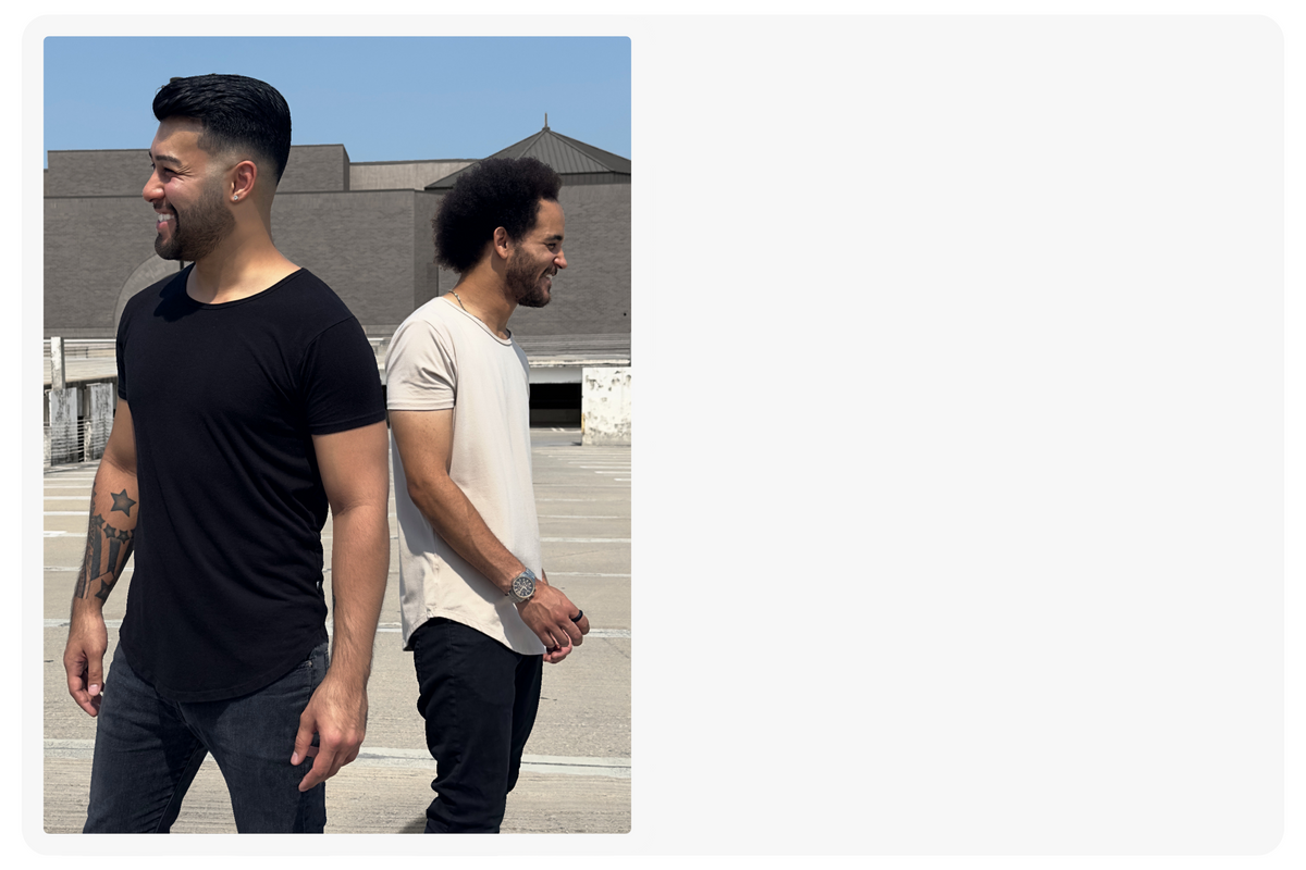 2 men standing together wearing the short sleeve drop tee in onyx black and sand beige